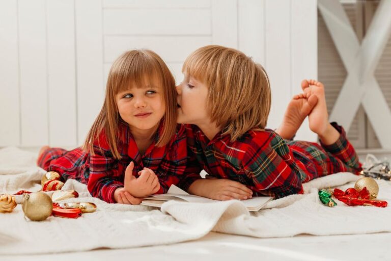 Two children whispering secrets while wearing plaid pajamas, symbolizing the playful theme of a snow day probability quiz.